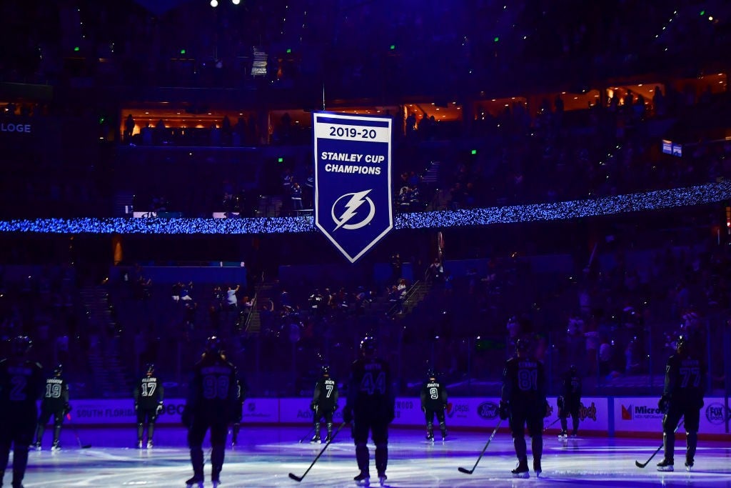 The Tampa Bay Lightning watch as the 2019-2020 Stanley Cup Championship banner is raised at Amalie Arena prior to a game against the Nashville Predators on March 13, 2021 in Tampa.